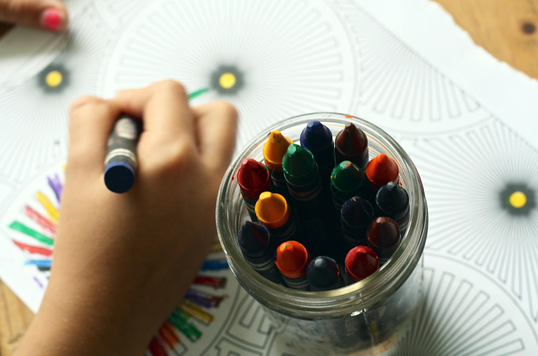 Child improving pencil grasp and hand-eye coordination while colouring during OT session in London, Ontario